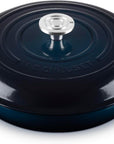 Le Creuset enameled cast iron oval lidded casserole dish in dark teal with a silver-tone knob, shown on a white background.