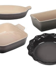 Set of 4 oyster Le Creuset Stoneware Heritage Bakeware set displayed on a white background