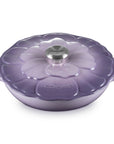 Purple cookware with floral lid on a white background