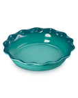 9 inch riviera Le Creuset stoneware pie dish displayed on a white background