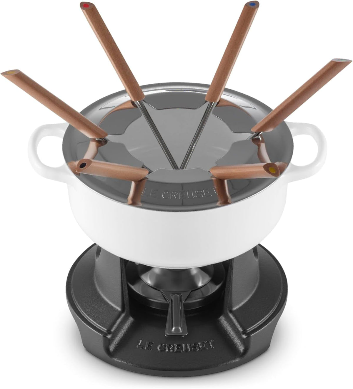 Le Creuset fondue set with a white ceramic pot, black cast-iron base, and six copper-colored wax melting wicks with dark handles, shown on a white background.