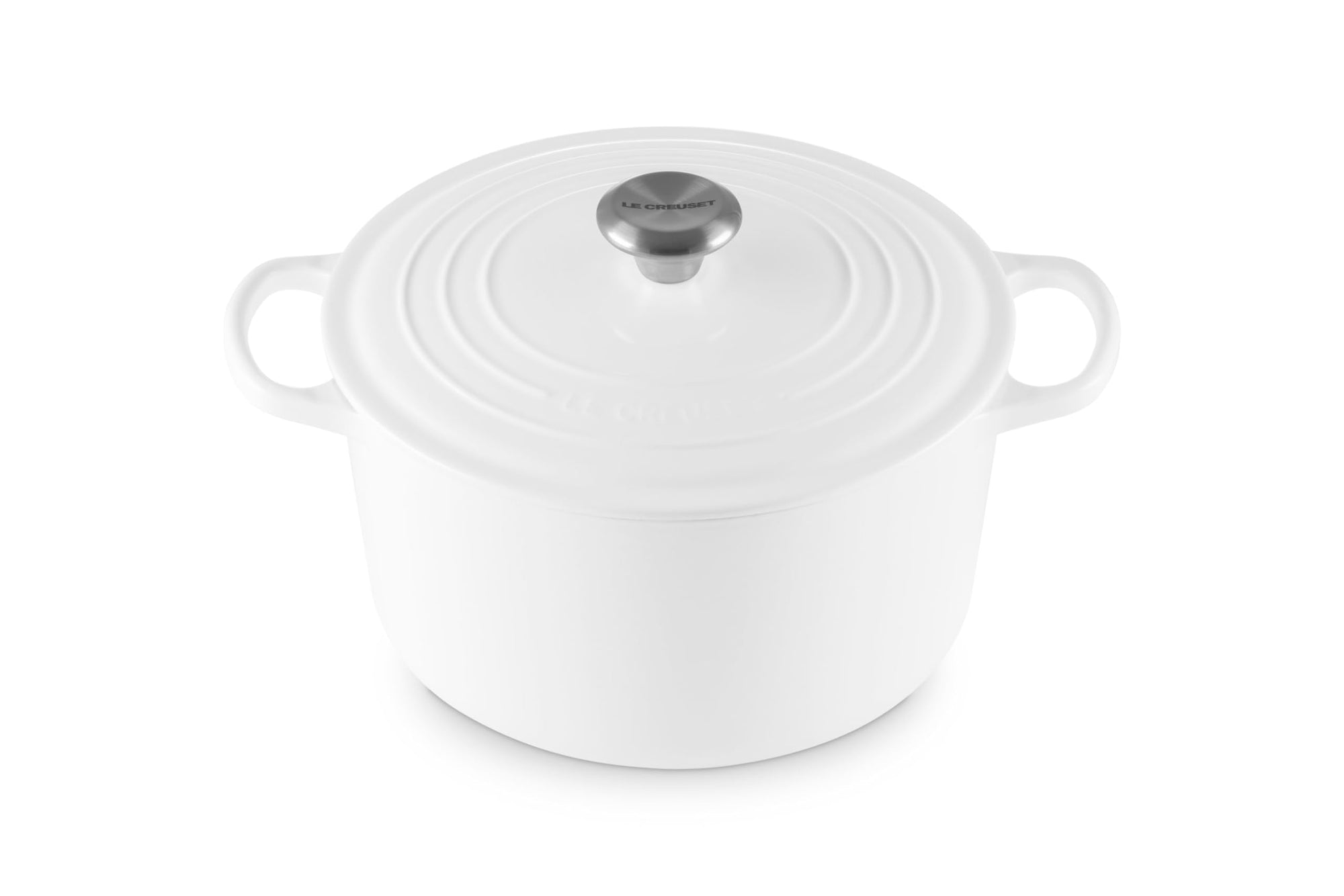 White enameled cast iron Dutch oven with a lid on a white background