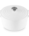 White enameled cast iron Dutch oven with a lid on a white background