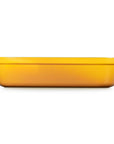 A rectangular yellow casserole dish with side handles, shown from a front-facing perspective on a solid white background.