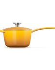 A yellow enameled saucepan with a matching lid and long handle, photographed on a clean white background.