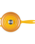 A bright yellow cast iron Dutch oven with a lid, shown from a top-down view on a solid white background.