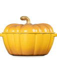 A yellow pumpkin-shaped enameled cast iron Dutch oven with a matching lid and small side handles, shown on a plain white background.