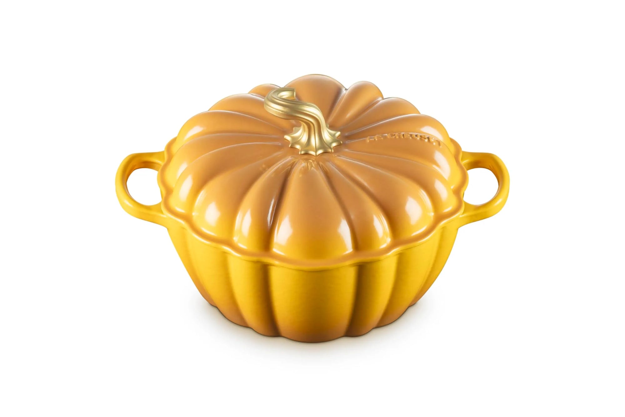A pumpkin-shaped enameled cast iron casserole dish with a lid, featuring a glossy orange-yellow finish and a small gold-toned faux stem on a white background.