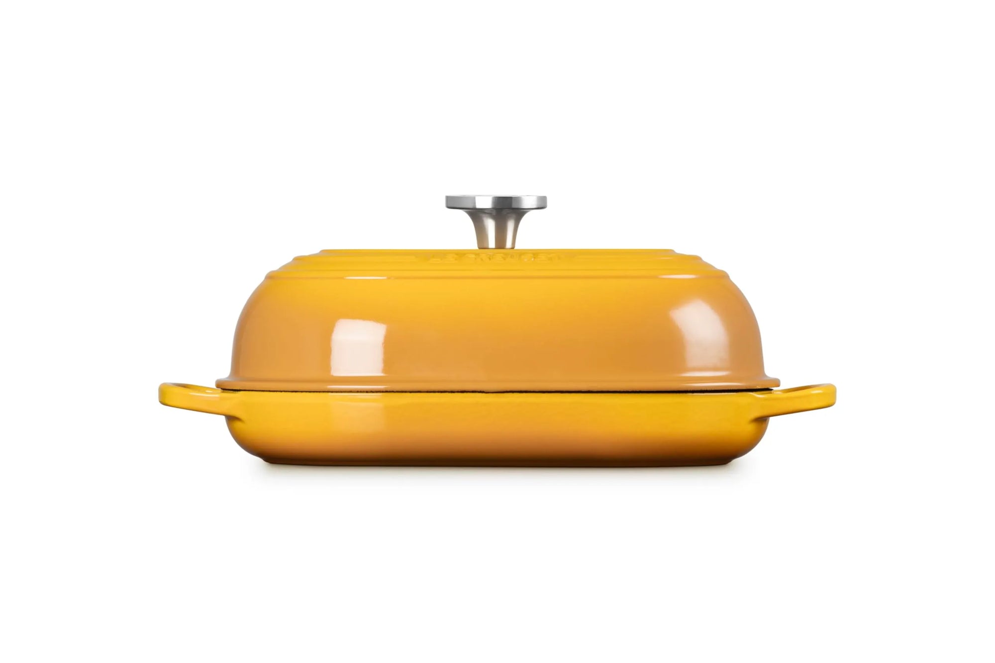 A round yellow enameled cast iron casserole dish with a matching lid and side handles, featuring a silver metal knob on top, set against a plain white background.
