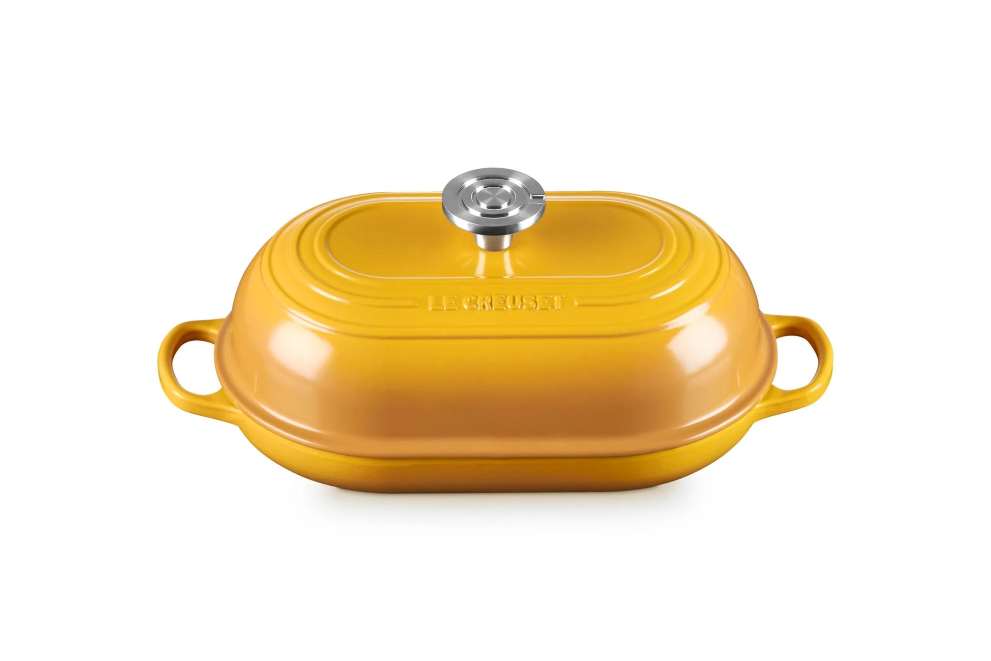 A yellow Le Creuset lidded casserole dish with side handles and a silver knob, shown on a clean white background.