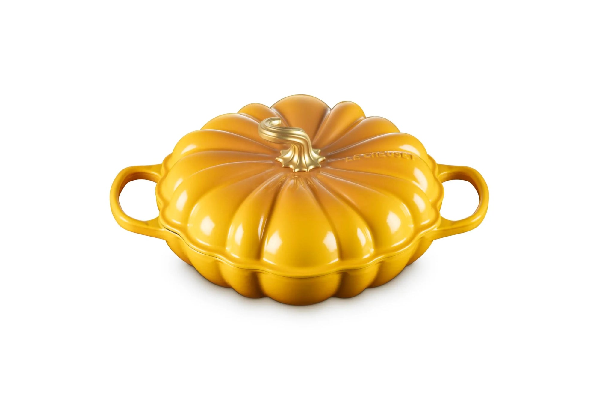 A yellow pumpkin-shaped enameled cast iron Dutch oven with two side handles and a matching lid, shown on a solid white background.