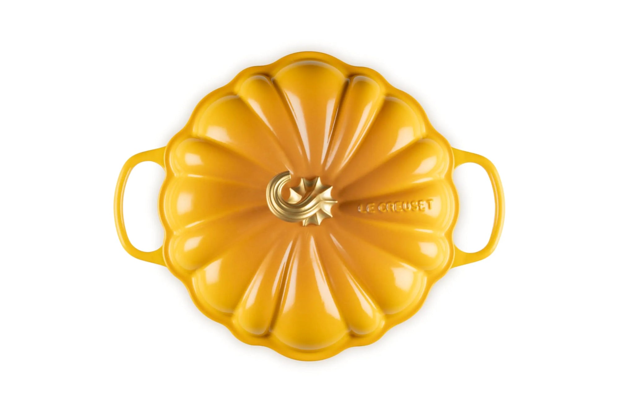 A yellow enameled cast iron Dutch oven with a pumpkin-shaped lid and side handles, photographed from a top-down perspective on a white background.