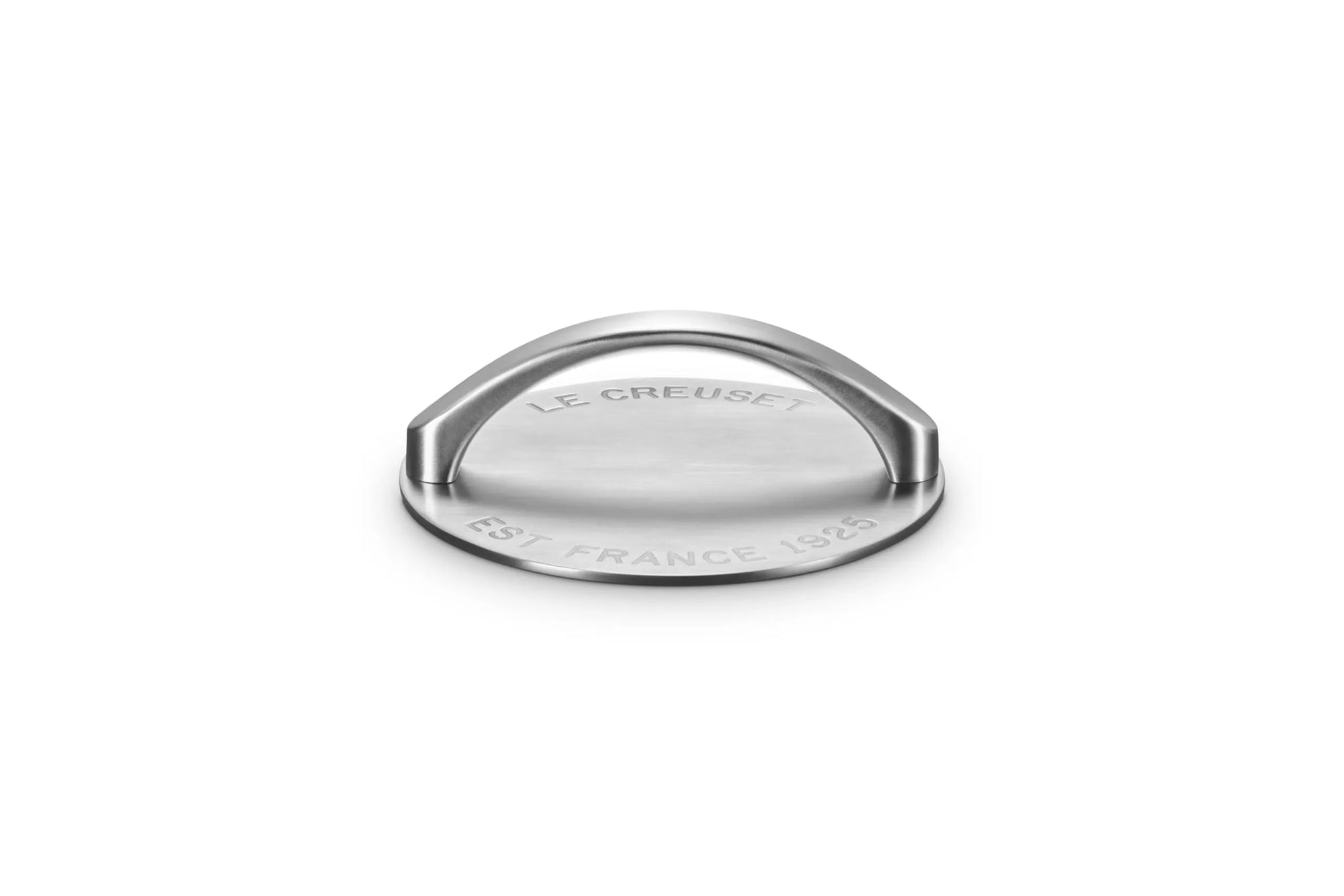 A Le Creuset round grill press with a semi-circular handle, featuring engraved 'LE CREUSET' and 'EST FRANCE 1925' text, shown on a clean white background.