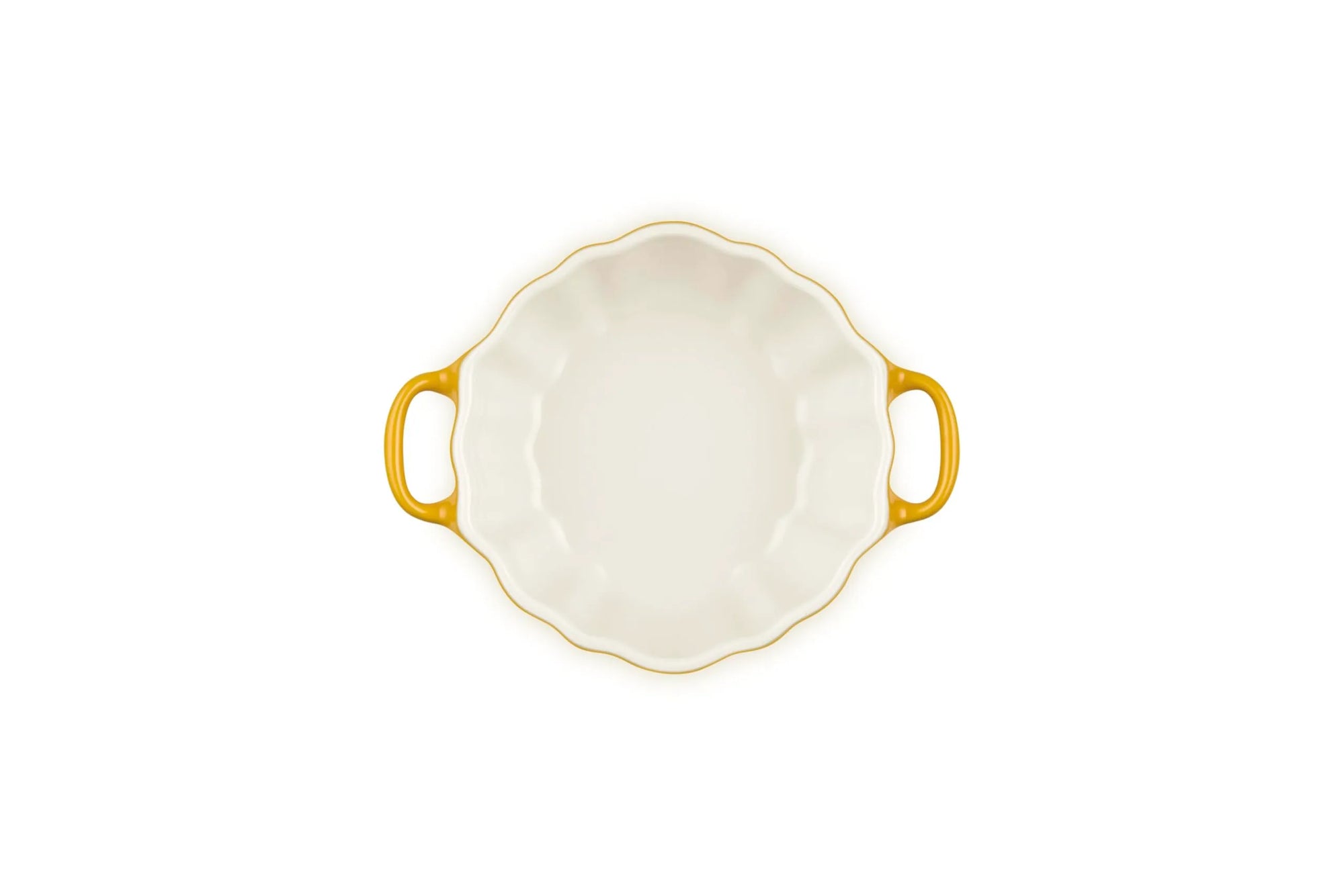 A white ceramic baking dish with a scalloped rim, two yellow handles, and a yellow-gold rim, shown from a top-down view on a white background.