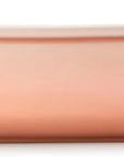 Side view of a peach rectangular baking casserole dish with two small loop handles on the sides, shown from a front-facing perspective on a solid white background.
