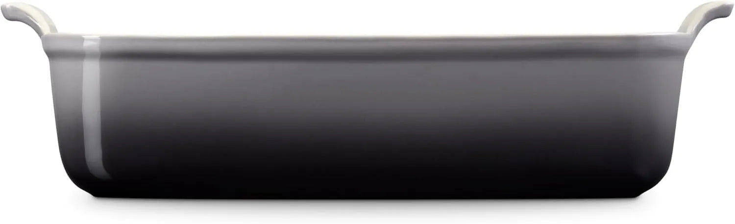 Side view of a dark gray rectangular baking casserole dish with two small loop handles on the sides, shown from a front-facing perspective on a solid white background.
