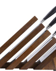 Set of knives stored within a block on a white background