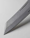 Close-up of a knife blade with Messermeister branding on a light gray background