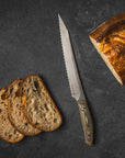 Sliced bread with a bread knife on a dark surface
