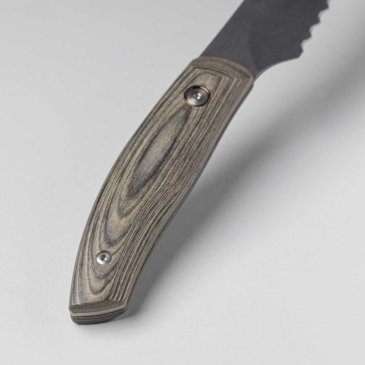 Close-up of a knife with a wooden handle on a light gray background
