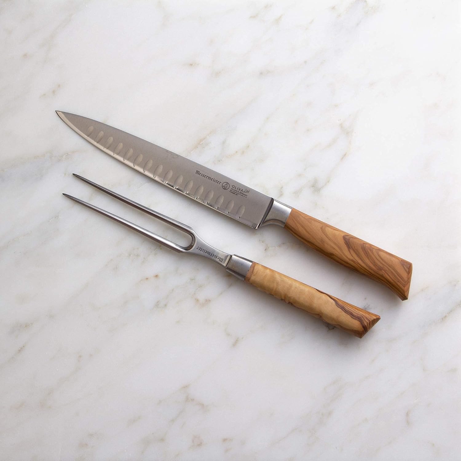 Carving set with wooden handles on a marble surface