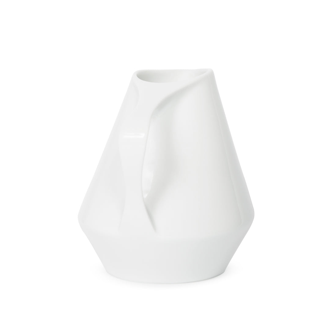 Side view of white ceramic pitcher on a white background