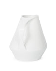 Side view of white ceramic pitcher on a white background