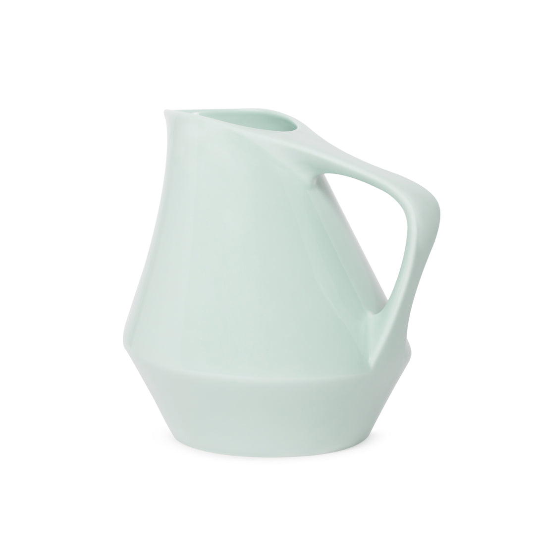 Sage green ceramic pitcher on a white background