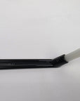 Black plastic tool with a white brush on a white background