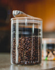 Life image of airscape glass container with bamboo lid in a kitchen setting with a scoop on top