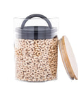 Airscape glass jar with cereal inside and airtight lid as well as a bamboo lid on the side on a white background