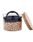 Small glass airscape container with an airtight lid and a bamboo lid on a white background