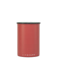 Red cylindrical container with black lid on a white background