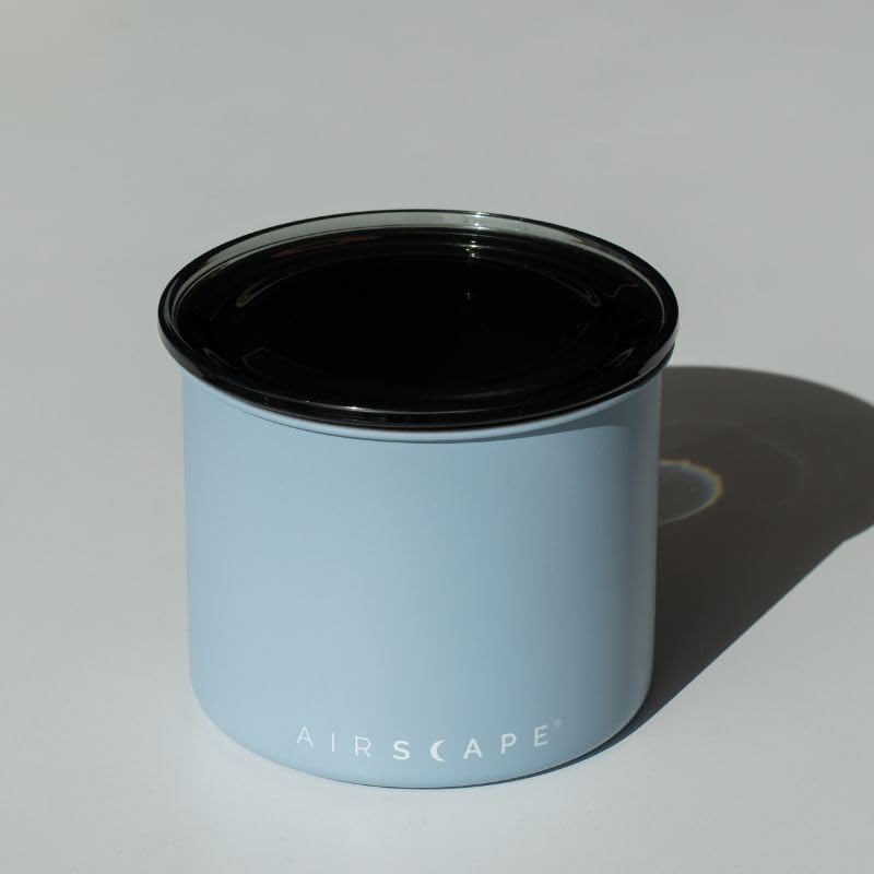 Light blue container with black lid on a white background