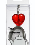 A red heart-shaped tea infuser with a silver metal strainer and keychain ring, packaged in a clear plastic blister pack with a white backing card. The packaging features a printed illustration of a white teapot and the text 'Tea Infuser'.