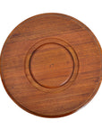 Wooden round tray with concentric circle design on a white background