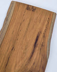 Wooden cutting board with 'Rico & Plato' branding on a white background