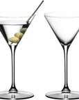 Two martini glasses with olive slices and a straw on a white background