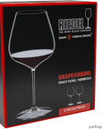 Riedel wine glass packaging with a glass of red wine on a black background