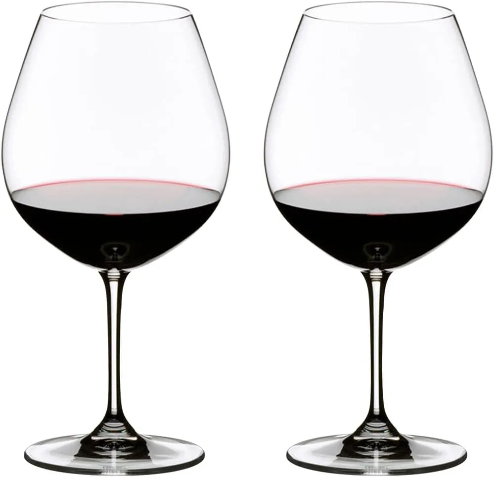 Two clear stemmed wine glasses filled with red wine, shown side by side on a plain white background.