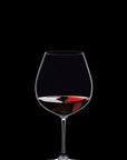 Wine glass with red wine on a black background