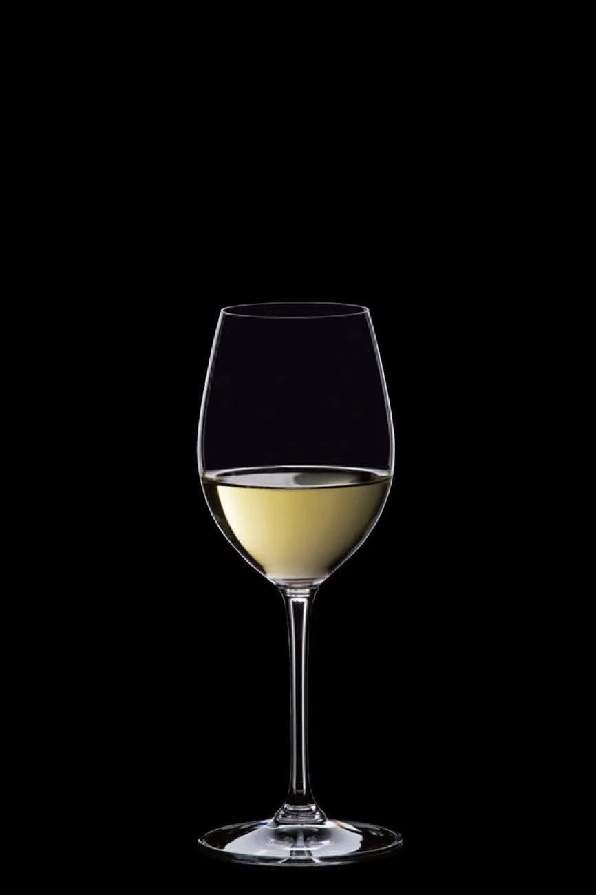 Wine glass with white wine on a black background