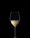 Wine glass with white wine on a black background