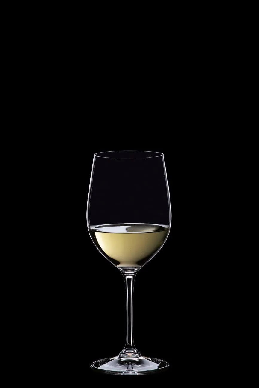 A clear wine glass partially filled with white wine, centered against a solid black background.