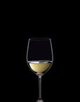 A clear wine glass partially filled with white wine, centered against a solid black background.