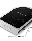 Portable induction cooktop with Smeg branding on a white background