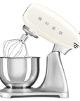 Cream-colored stand mixer with whisk attachment slanted open on a white background