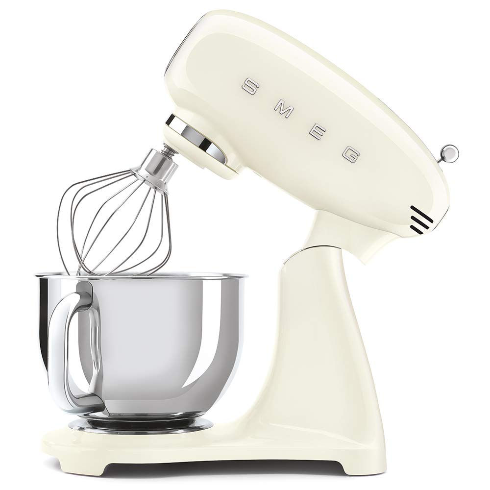 Cream-colored stand mixer slanted open with whisk attachment on a white background