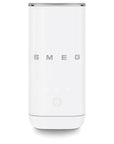 A white milk frother with the brand name SMEG in silver lettering on the front, featuring a circular button and three small indicator lights below the logo.