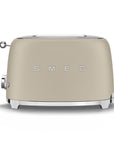 Front view of matte beige toaster with 'Smeg' branding on a white background
